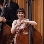 A woman smiling with her double bass