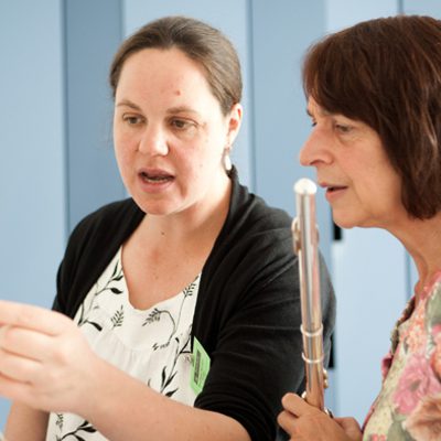 two women - a tutor and student studying music on a stand